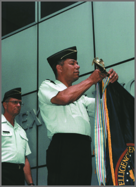 Image of General Colin Powell presenting the Meritorious Unit Award.
